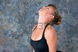 autiful-woman-has-her-eyes-closed-and-he-tilted-back-as-she-arches-back-into-posture-upward-faci.jpg